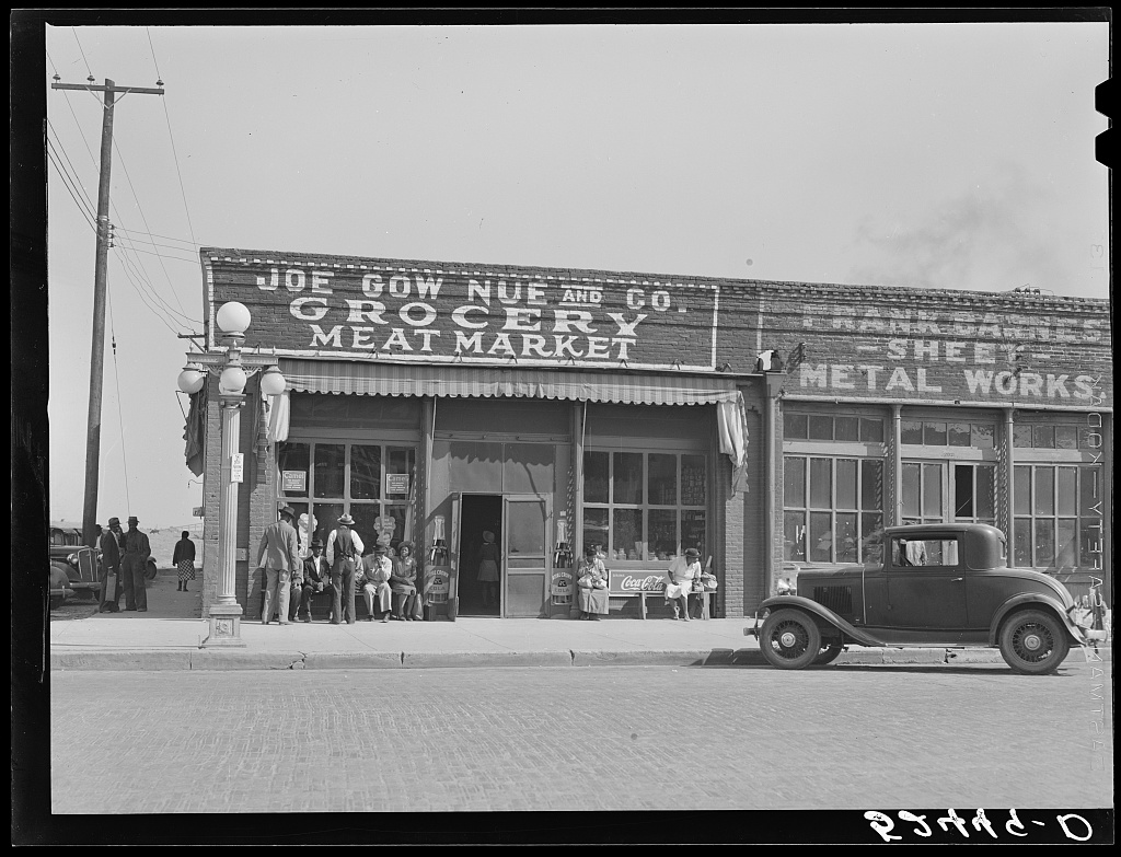 A wider view of the Leland grocery storefront and neighboring businesses